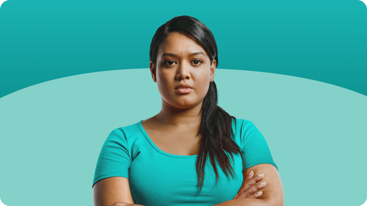 Young woman in a teal top with arms crossed