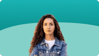 Young woman with long hair wearing a denim jacket, arms crossed